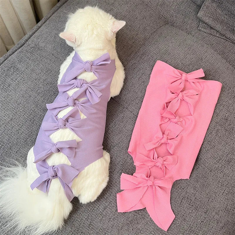 Lace-up polyester recovery clothing for a cat, shown in a choice of colours including blue, pink, and green pineapple.
