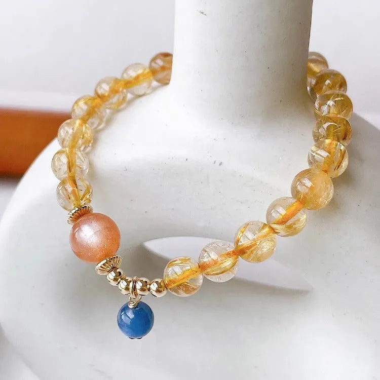 Women's gold rutilated quartz sunstone crystal bracelet with diamond-shaped beads