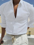 Man's blue and white striped button-up shirt with a lapel collar and long sleeves.