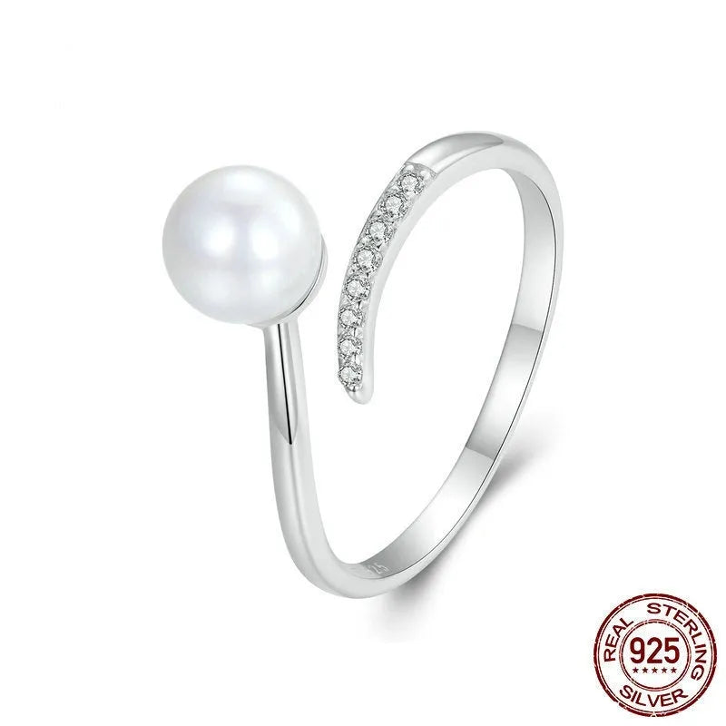 Women's sterling silver adjustable ring with shell pearls on open loop design