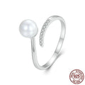 Women's sterling silver adjustable ring with shell pearls on open loop design