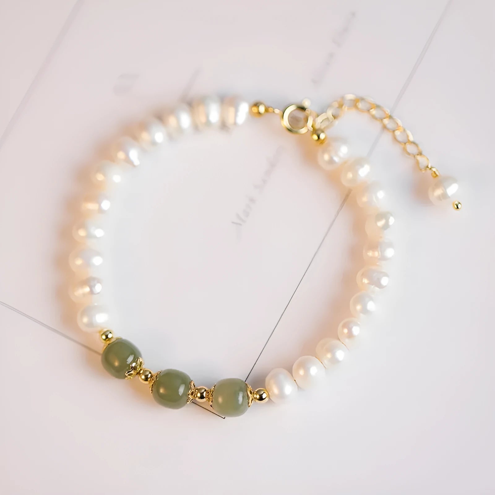 Natural freshwater pearl bracelet with diamond-shaped beads in Hetian jade colours on wrist