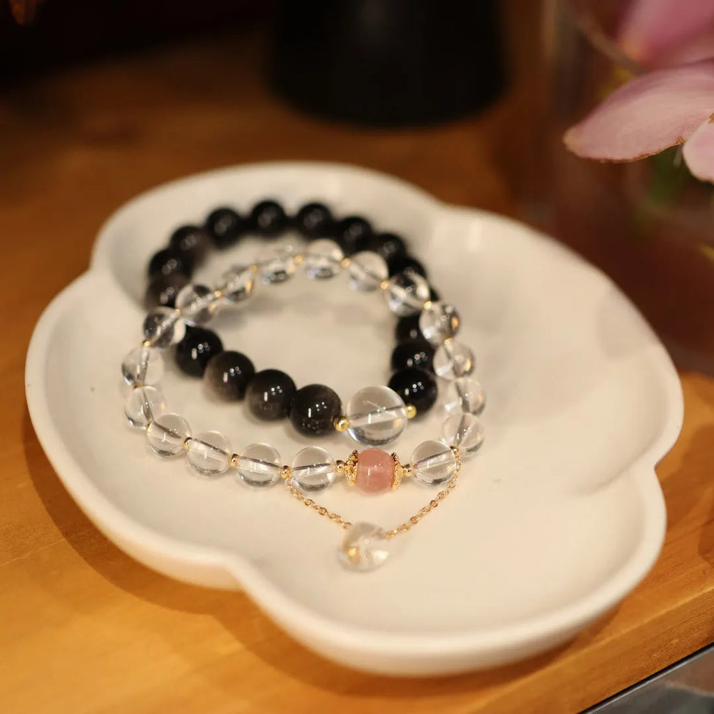 Chinese style geometric crystal bracelet with cat eye obsidian stone and auspicious patterns.