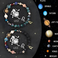 Two adjustable natural stone beaded bracelets with small metal zodiac charms on a woven thread.