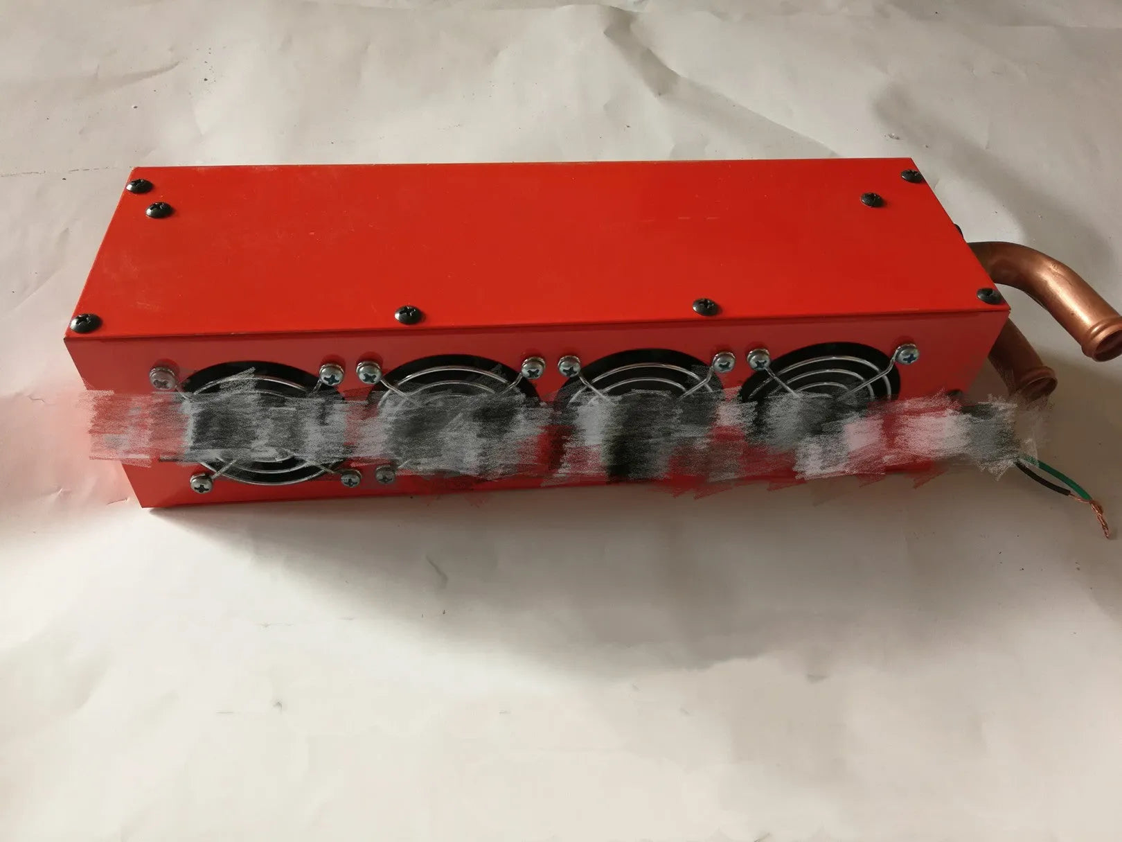 Compact metal car heater with copper pipe connections for 12V or 24V vehicle installation.