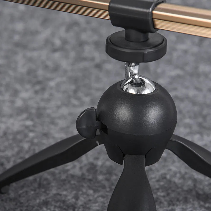Silver aluminium tripod ice fishing rod holder bracket on ice.