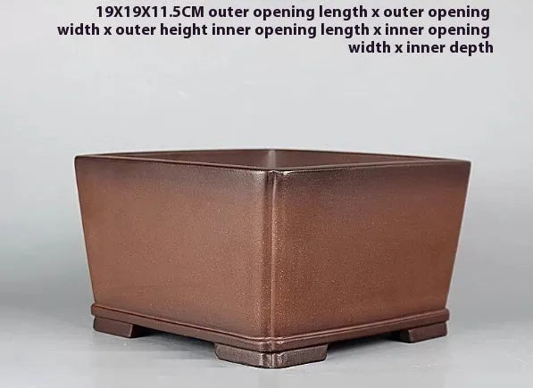 Handmade brown antique purple clay classical flower pot with a drainage hole.