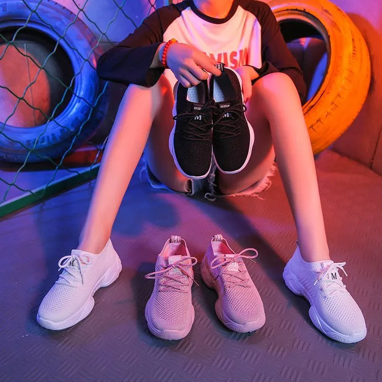 Women's white thick-soled sports shoes with a woven upper and front strap in a candy colour.