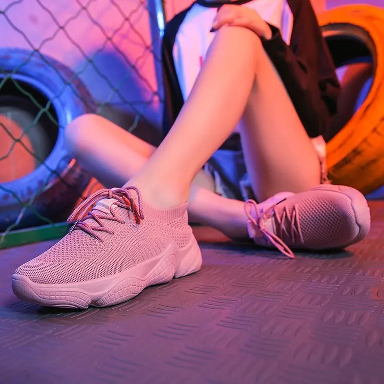 Women's white thick-soled sports shoes with a woven upper and front strap in a candy colour.