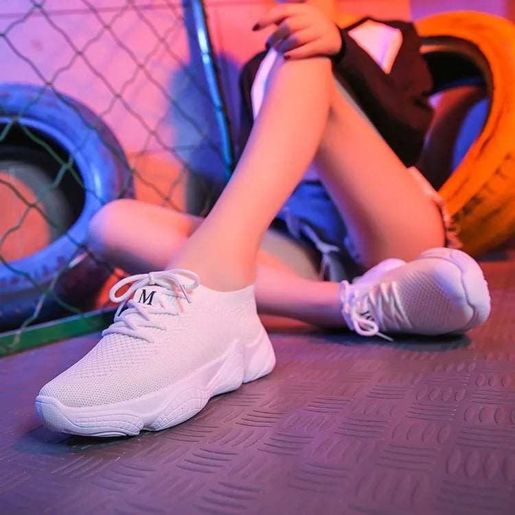 Women's white thick-soled sports shoes with a woven upper and front strap in a candy colour.