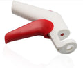 Cherry pitter kitchen tool with soft-grip handle and stainless steel plunger on a plastic base.