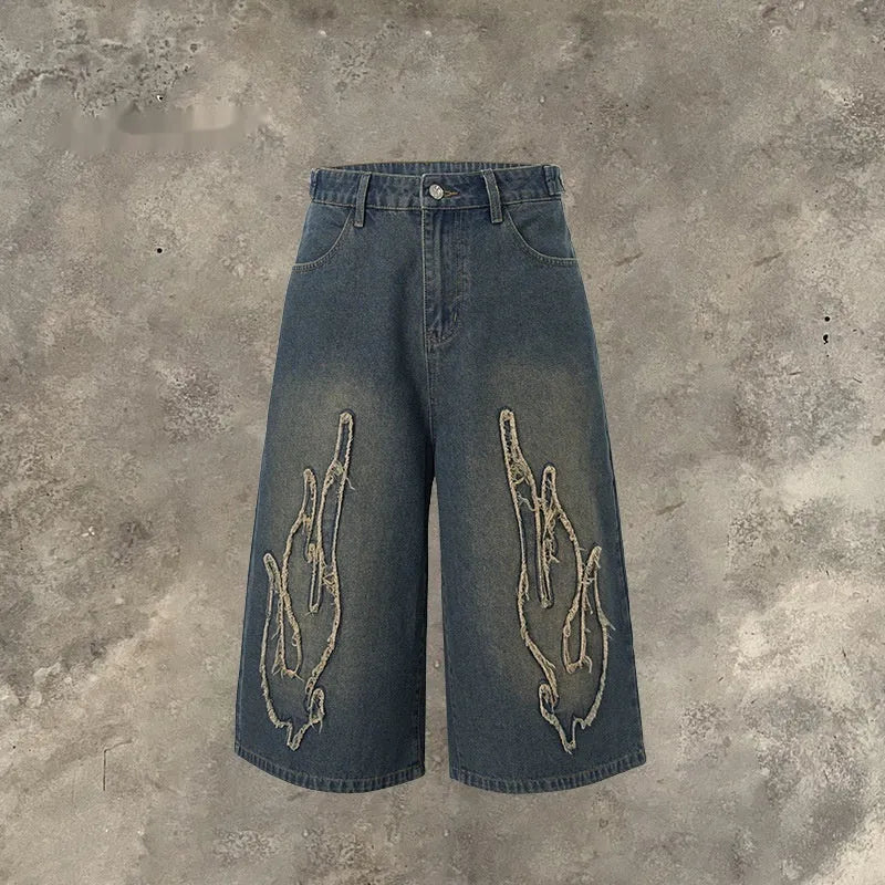 Men's cropped denim shorts with flame embroidery patches in straight cut design for summer street style