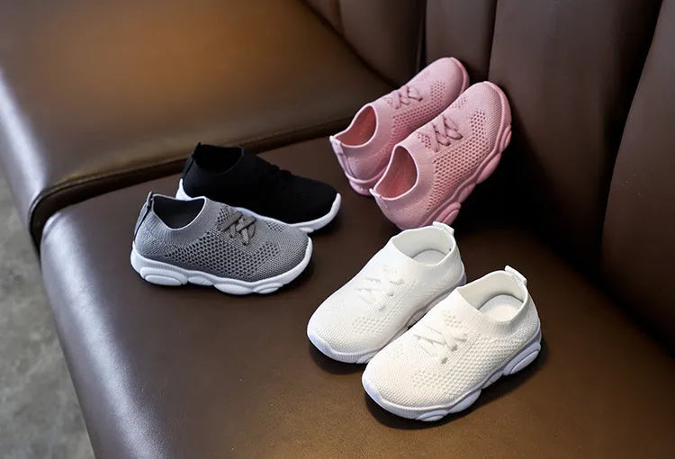 Children's fabric lazy shoes in white, black, pink, and grey colours with non-slip rubber sole
