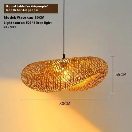 Natural bamboo straw hat-shaped pendant lamp shade hanging from a ceiling, showing its woven texture.
