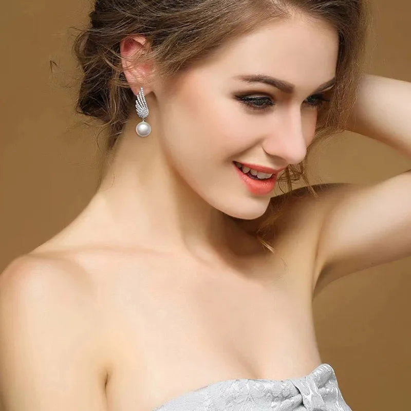 Silver angel wing earrings with gold-plated gemstone inlay and platinum colour finish