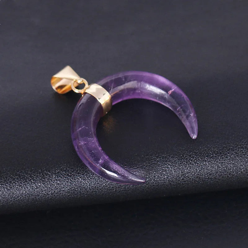 Close-up of an adjustable moon pendant necklace with a natural purple stone on a copper chain.