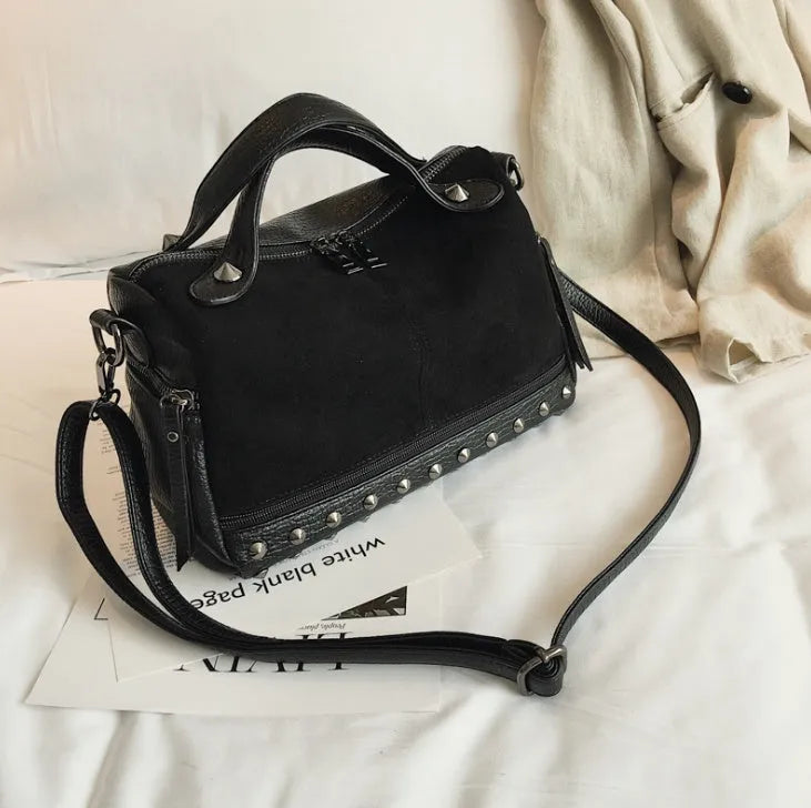 Soft grey PU leather women's tote shoulder bag with zip top on a table