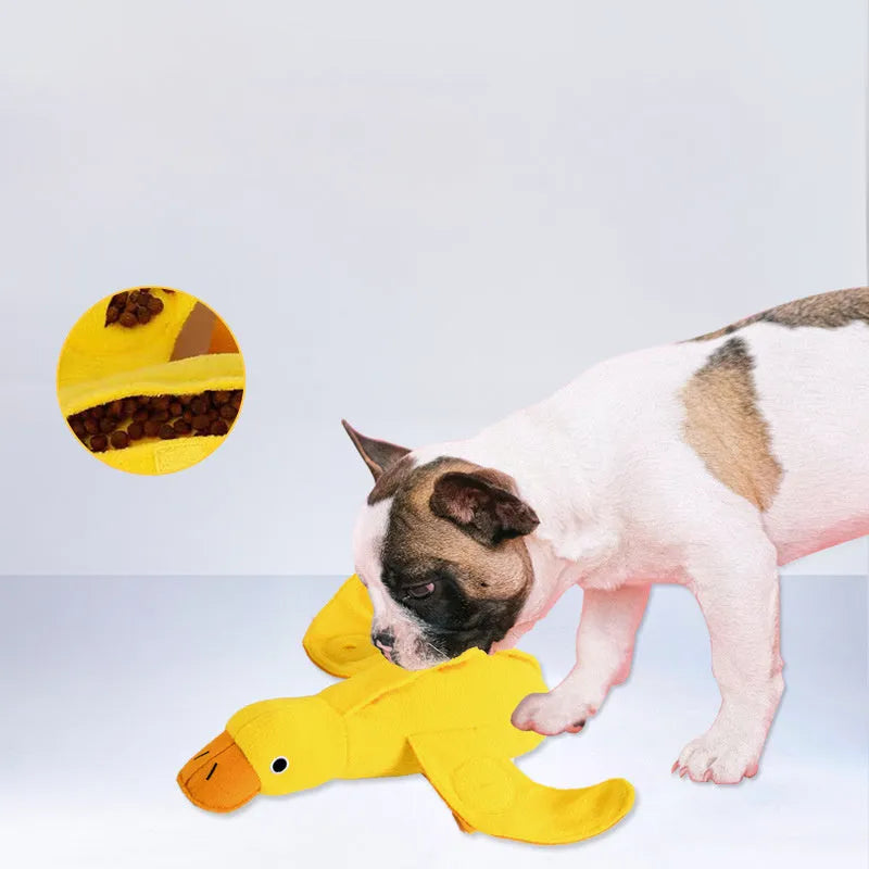 Yellow plush teddy bear dog toy with an attached duck doll, featuring a squeaker and treat compartment.