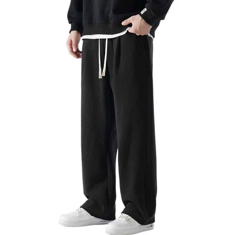 Man wearing apricot coloured double-sided polar fleece winter trousers with a loose fit and drawstring waist.