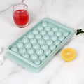 Blue silicone ice cube tray with lid showing 33 round moulds for large ice cubes