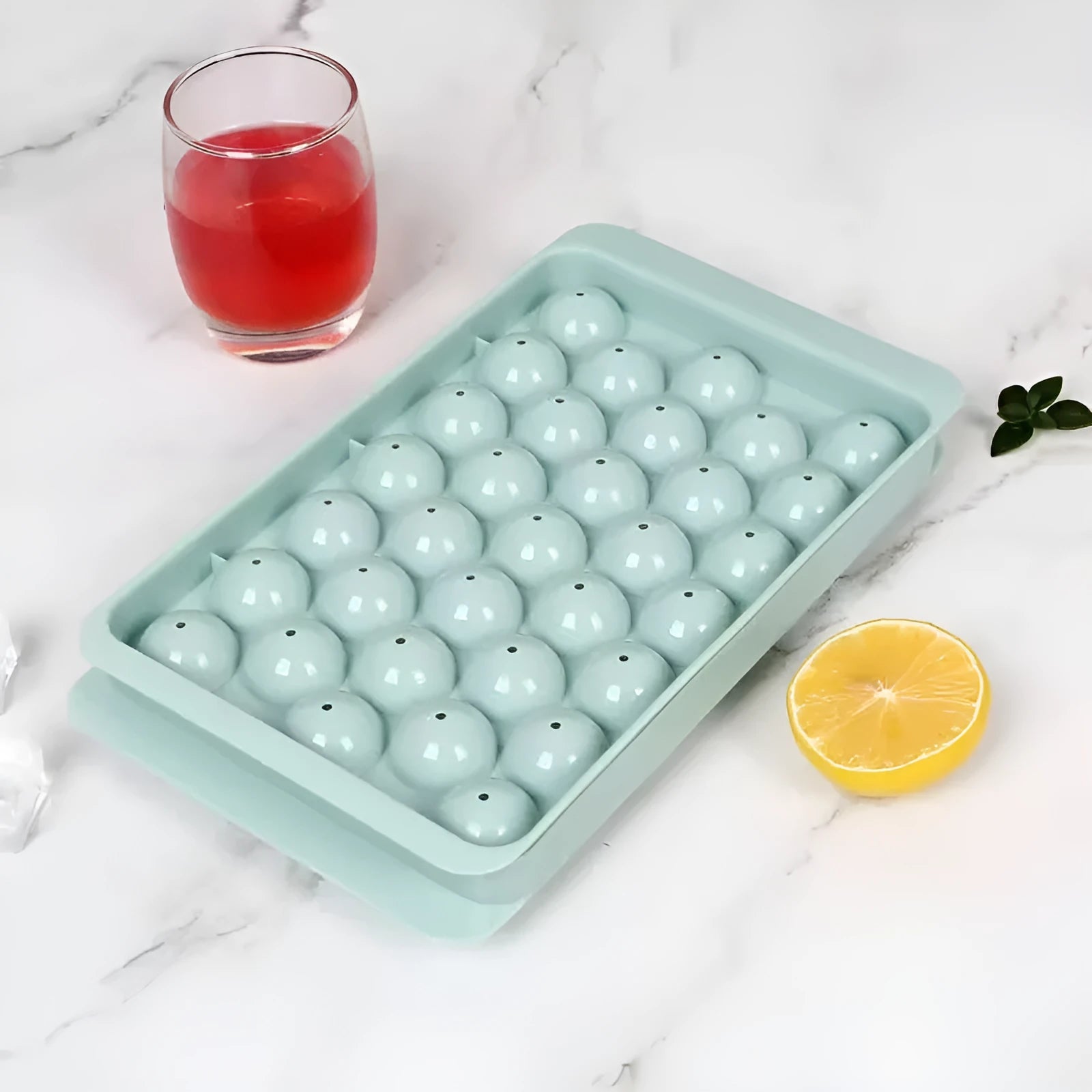 Blue silicone ice cube tray with lid showing 33 round moulds for large ice cubes