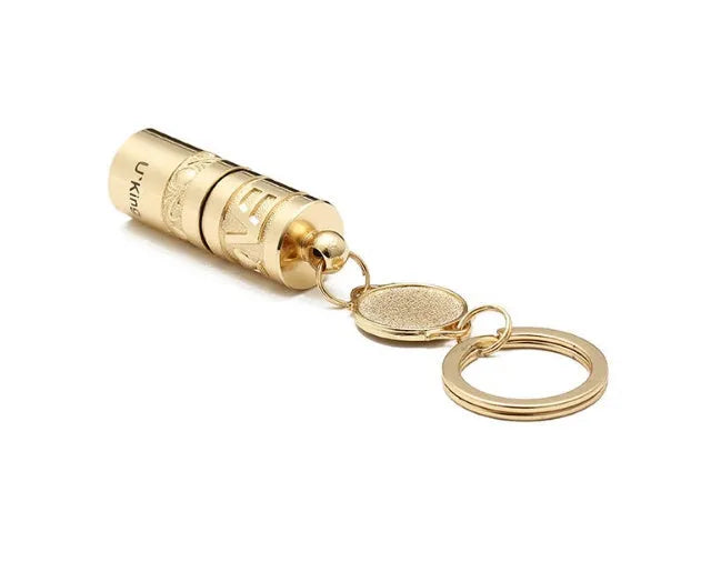 Gold electroplated zinc alloy portable LED keychain flashlight for outdoor emergency use.