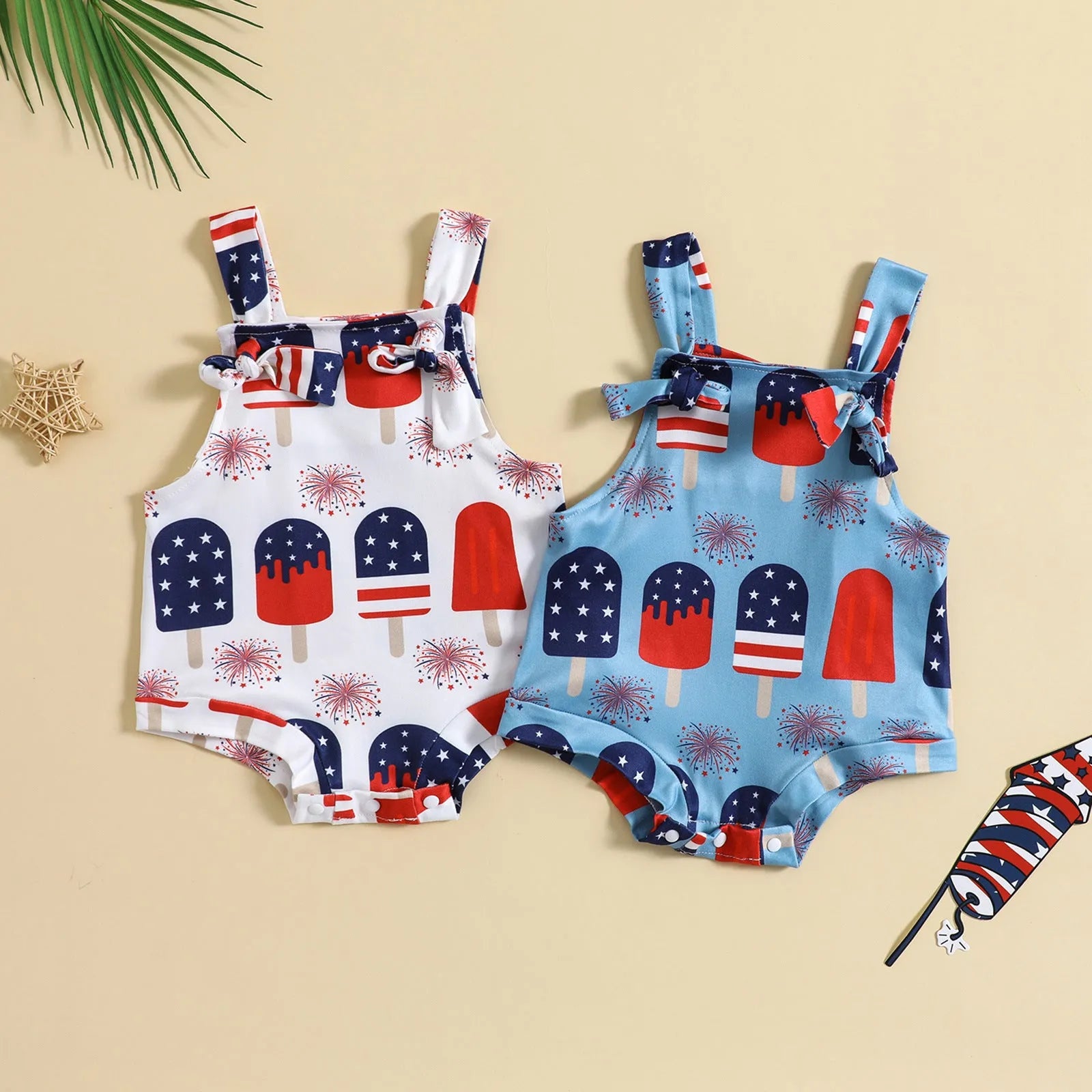 Baby girl wearing a sleeveless knotted front suspender pants jumpsuit in a printed design.