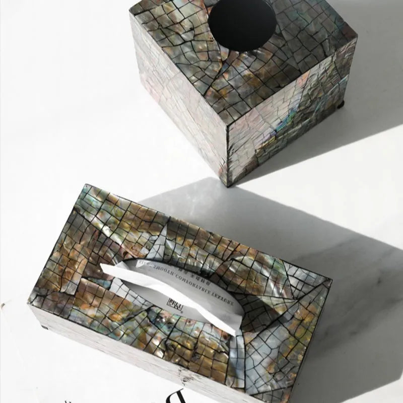 Natural shell decorative storage box tissue holder in square and rectangular shapes on a table.