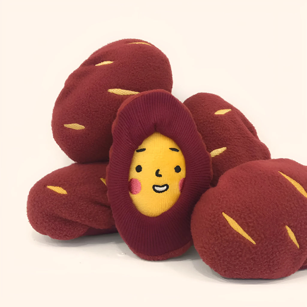 Red fabric pet toy shaped like sweet potato with internal hidden treat pockets for dogs