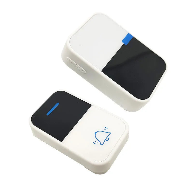 Modern white wireless doorbell receiver and self-generating transmitter on a table.