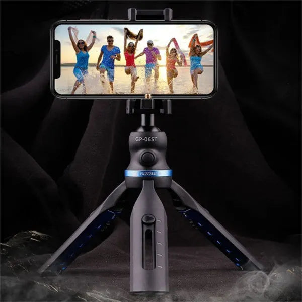 Black desktop tripod stand holding an iPhone X mobile phone.