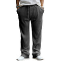 Man wearing loose high-waisted straight-leg casual trousers in a striped pattern.