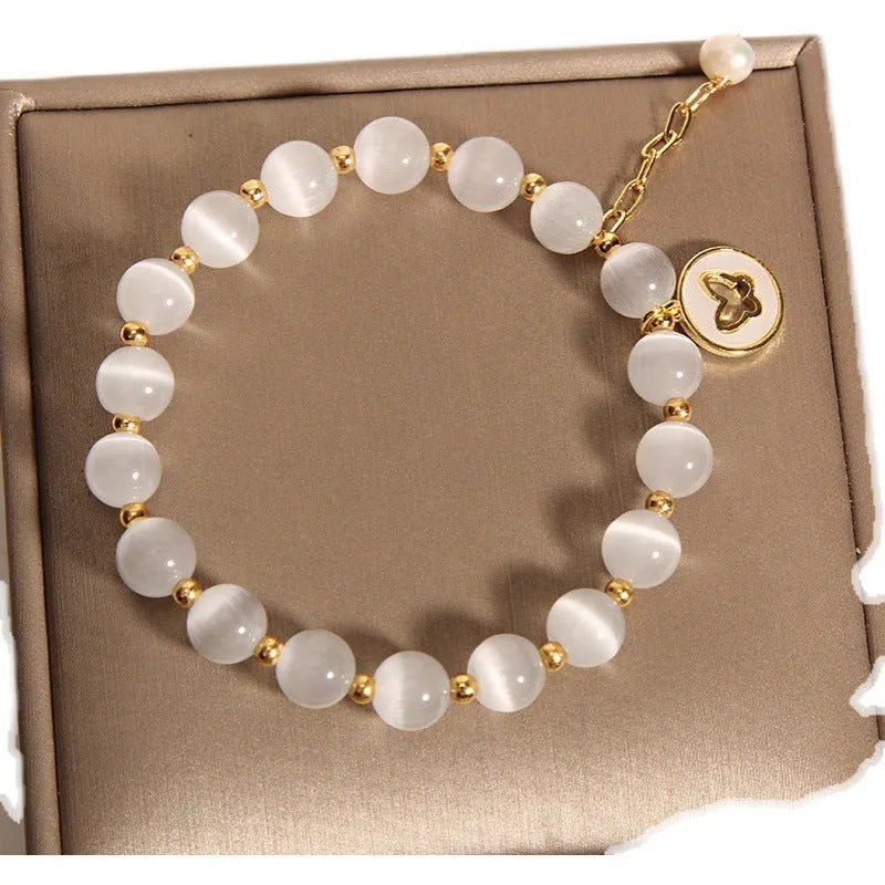 White Korean-style geometric bracelet with a cat's eye crystal on a stretch elastic band.
