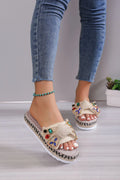 Creamy-white women's platform sandals with beach bow style and cloth construction on model foot