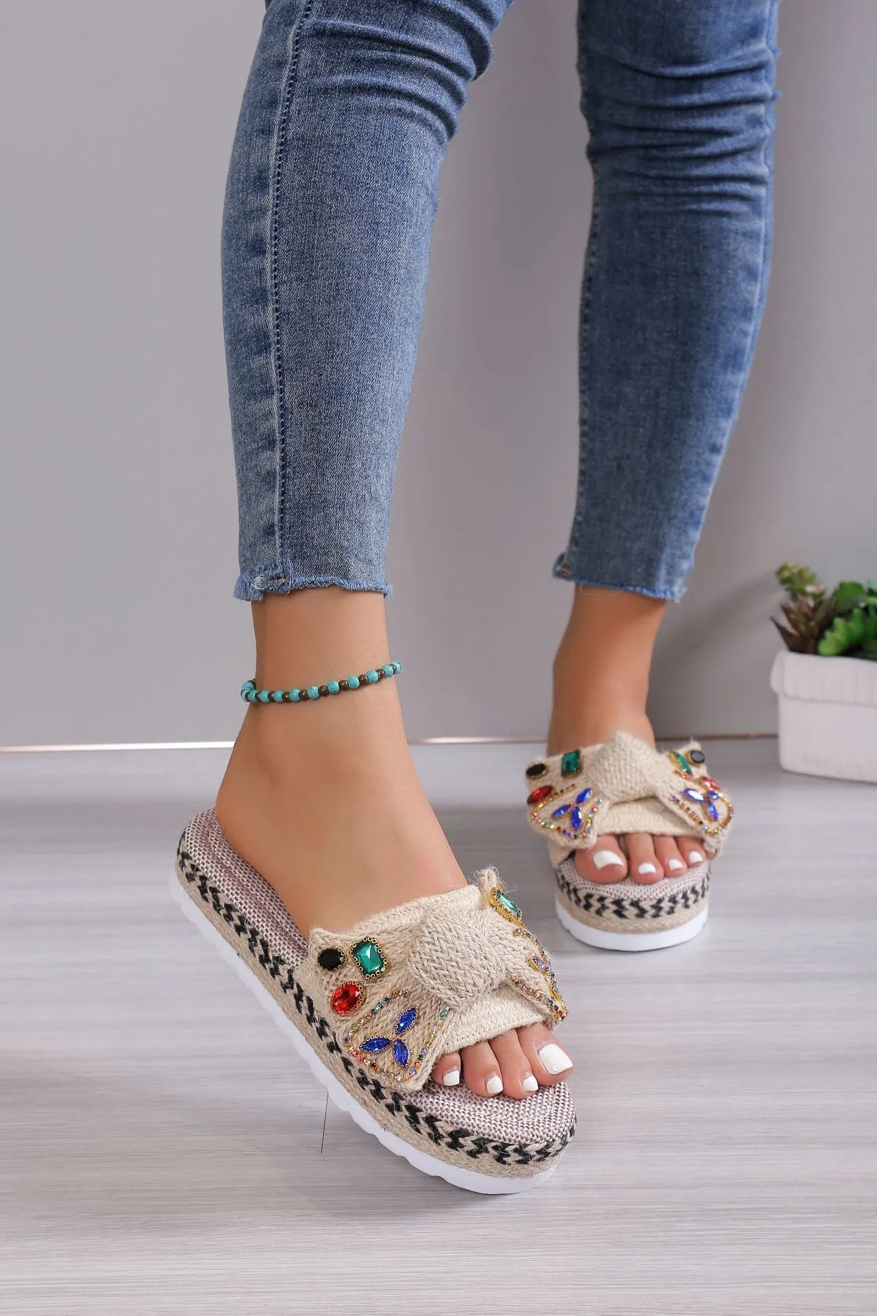 Creamy-white women's platform sandals with beach bow style and cloth construction on model foot