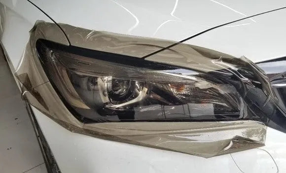 A roll of 30 cm wide TPU car lamp protective film for large LED lampshades, shown in a dark gray finish.