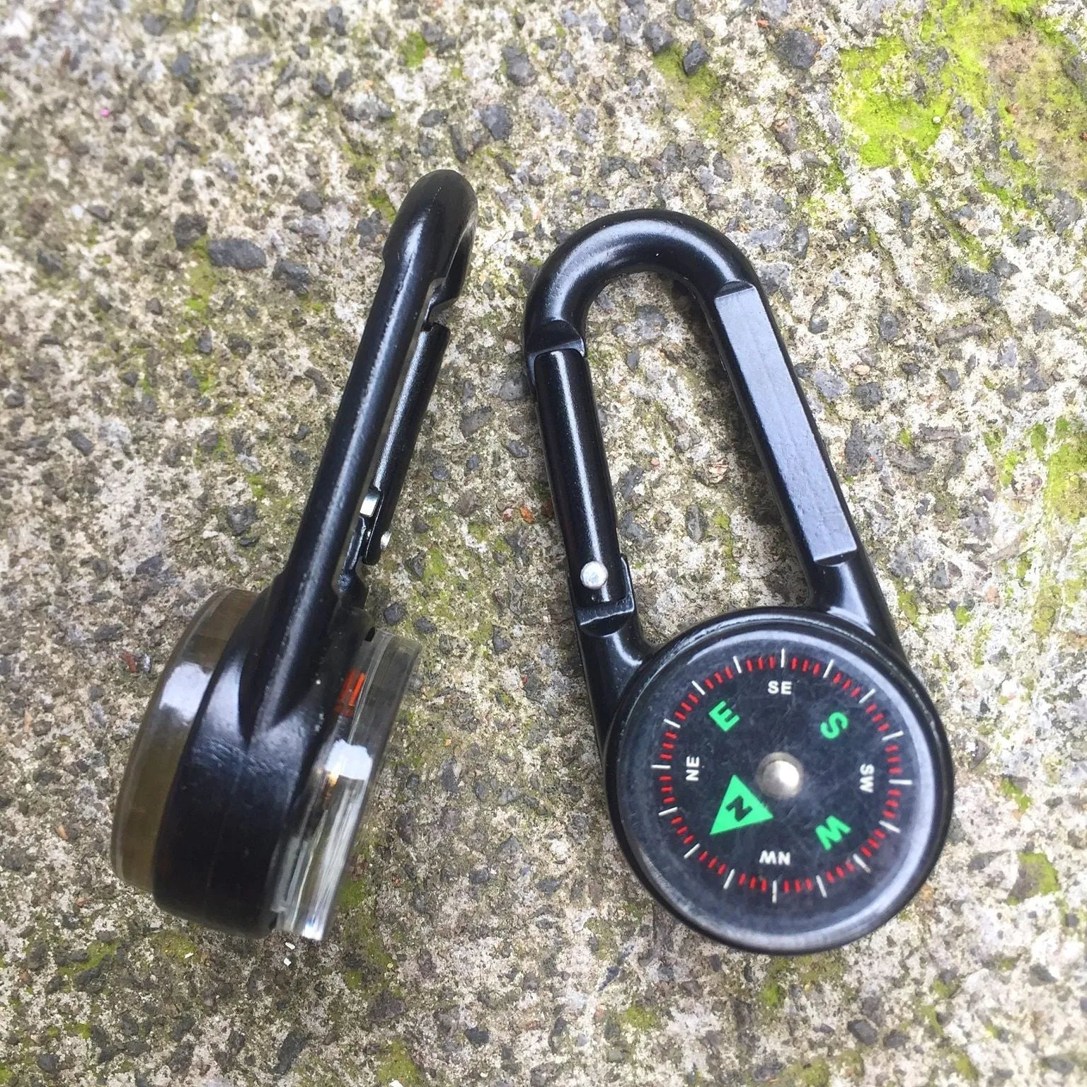 Black zinc alloy carabiner with built-in circular compass and rectangular thermometer display.