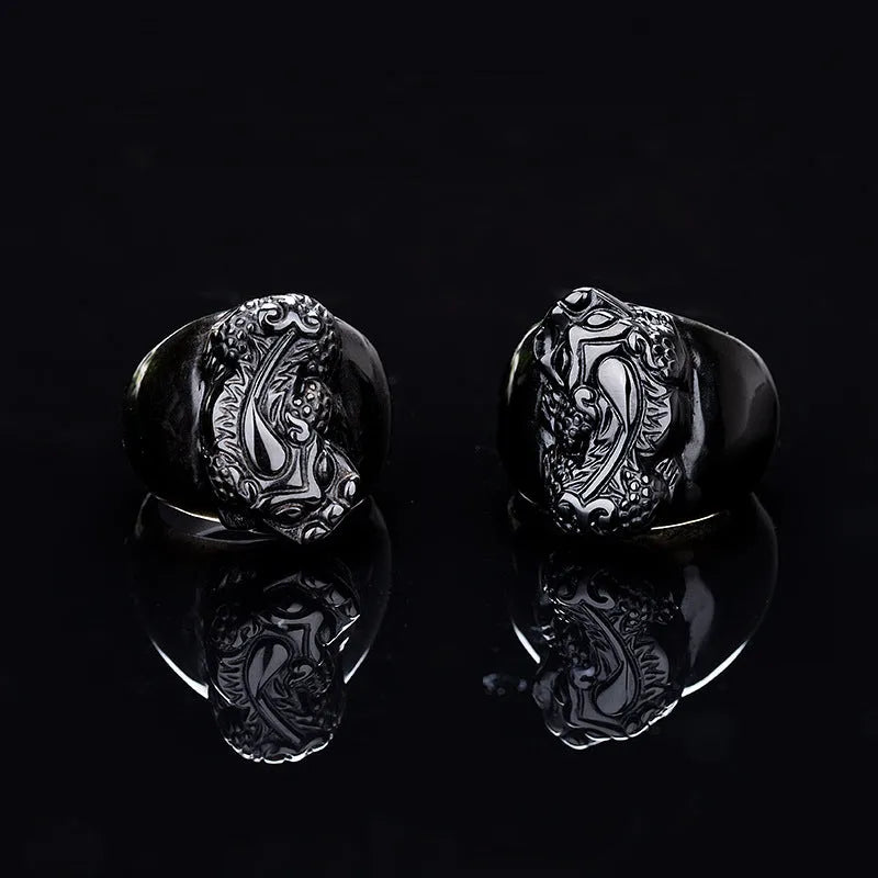 Men's chunky silver thumb ring with a black obsidian crystal showing gold sheen and a detailed Pixiu design.