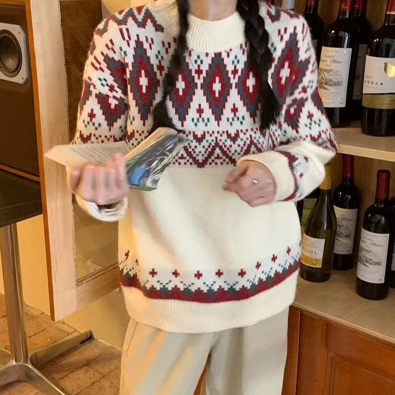 A woman wearing a loose red and white striped long-sleeved knitted pullover top.