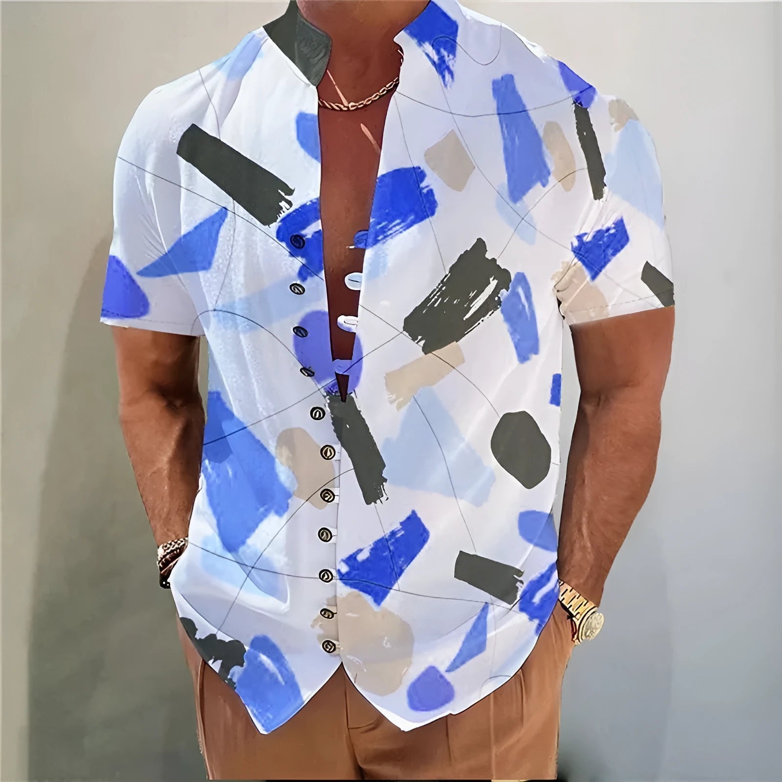 Youth model wearing a short sleeve cardigan with a blue and white geometric floral print pattern.