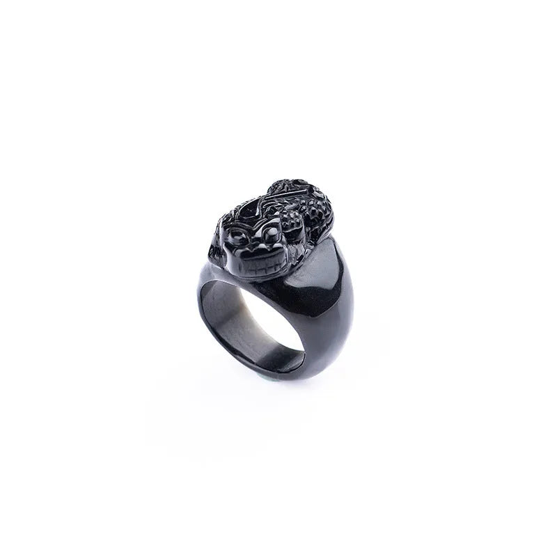 Men's chunky silver thumb ring with a black obsidian crystal showing gold sheen and a detailed Pixiu design.