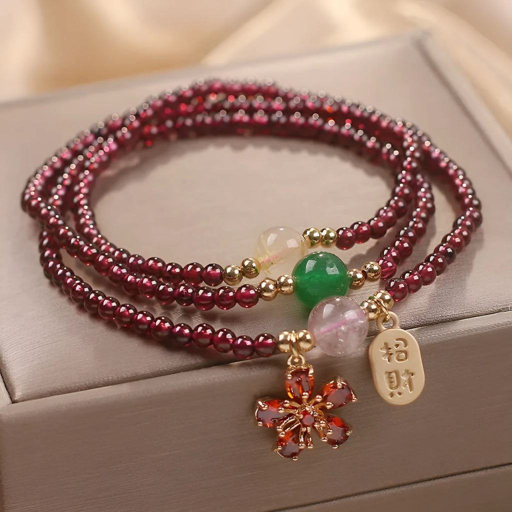 Women's simple bracelet made of red crystal with sequin accents on a wrist.