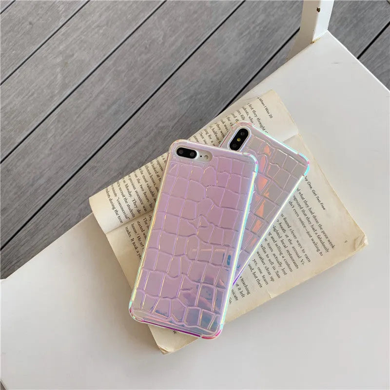 Silver glossy laser design silicone case for iPhone on a table.