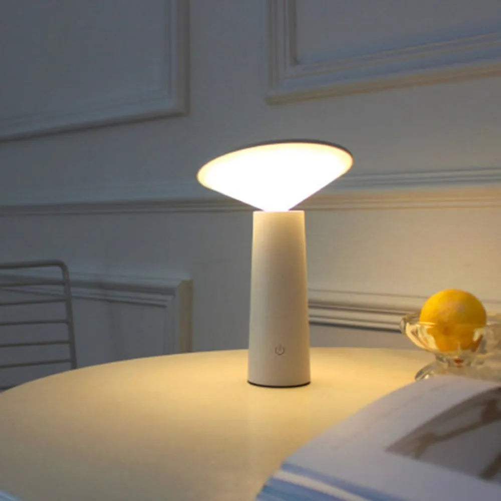 Black USB touch sensor table lamp with adjustable head on a wooden desk