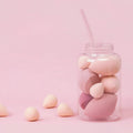 Set of 7 makeup sponge eggs in various colours inside transparent jar with multiple cut shapes