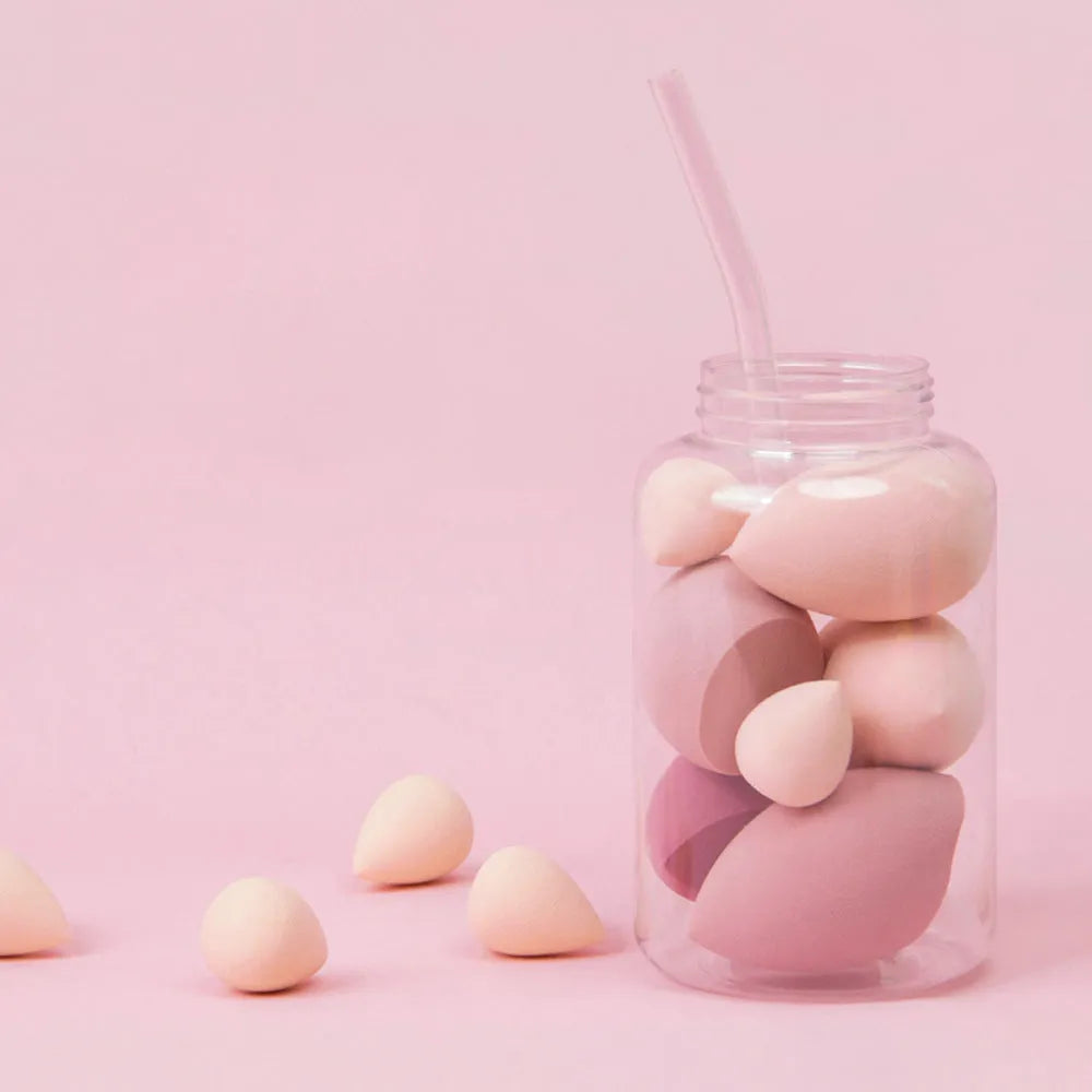 Set of 7 makeup sponge eggs in various colours inside transparent jar with multiple cut shapes