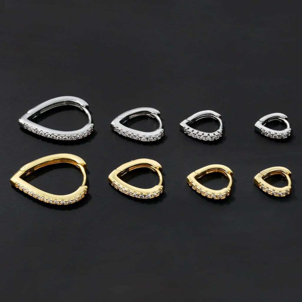 A geometric heart-shaped ear clip in a gold electroplated finish on a copper base.
