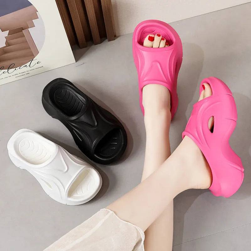 Women's white thick-soled EVA slippers with round toe for beach wear.