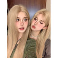 Women's long straight milk tea blonde gold wig with hair net on display