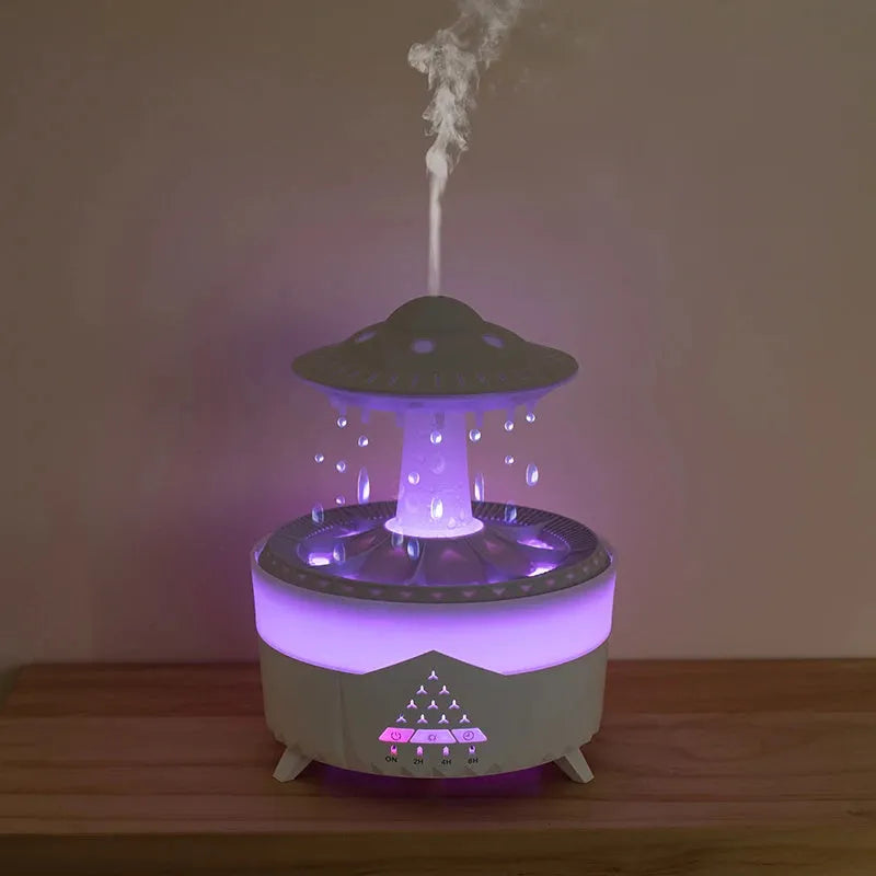 White cloud-shaped humidifier with raindrop mist and coloured night light on wooden table